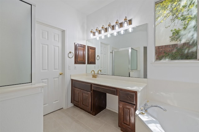 bathroom featuring independent shower and bath, tile patterned flooring, and vanity