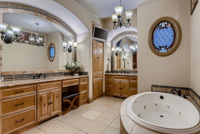 bathroom featuring vanity and tiled bath