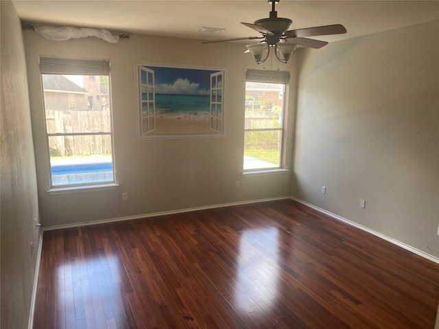 empty room featuring ceiling fan and dark hardwood / wood-style flooring