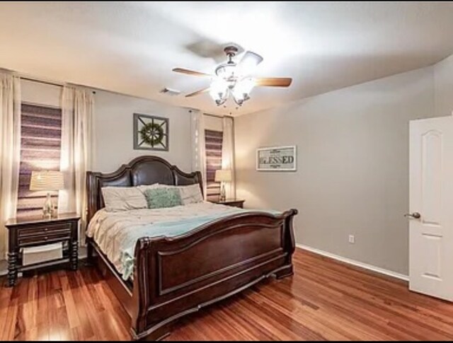 bedroom with ceiling fan and hardwood / wood-style flooring