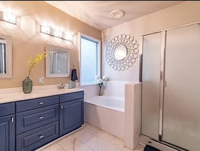 bathroom with shower with separate bathtub and vanity