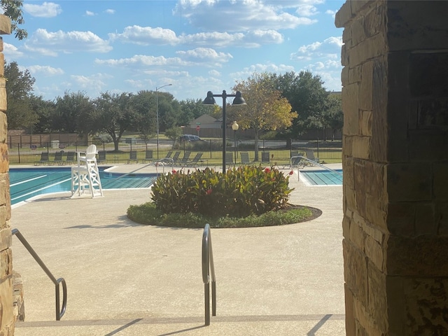 view of swimming pool featuring a patio area