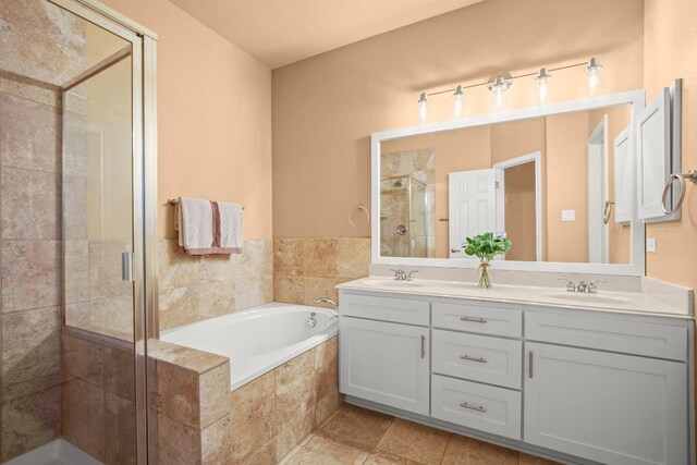 bathroom featuring vanity and shower with separate bathtub