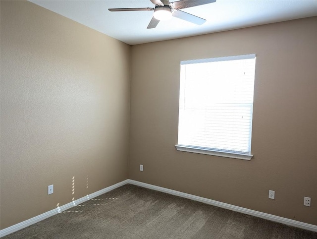 empty room with ceiling fan, carpet flooring, and baseboards