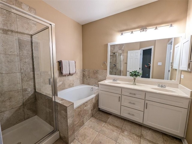 bathroom with double vanity, a sink, a bath, and a shower stall