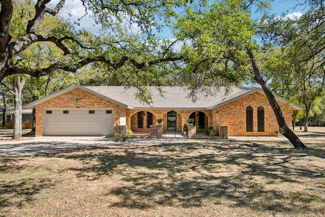 ranch-style home with a garage, a front lawn, and a porch