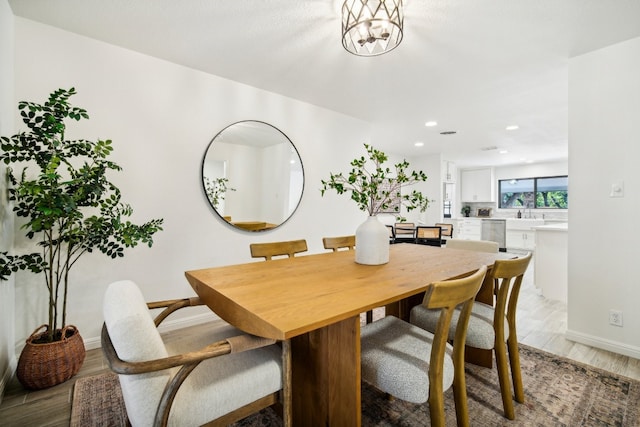 dining room featuring an inviting chandelier and light hardwood / wood-style flooring