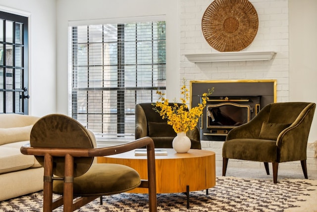 living area featuring a brick fireplace