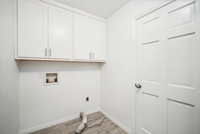 clothes washing area with hookup for a washing machine, cabinets, light hardwood / wood-style flooring, and hookup for an electric dryer