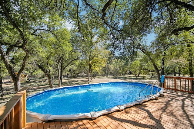 view of swimming pool with a deck