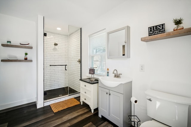 bathroom with vanity, hardwood / wood-style floors, toilet, and an enclosed shower