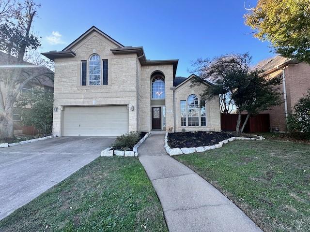 front of property with a front yard and a garage