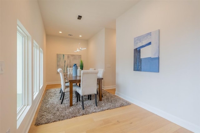dining space with wood finished floors, baseboards, and recessed lighting