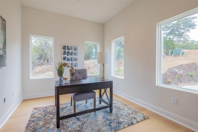 home office featuring light wood finished floors and baseboards