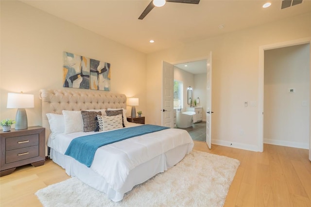 bedroom featuring ensuite bath, ceiling fan, and light wood-type flooring