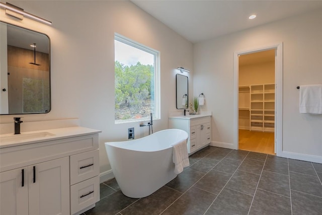 bathroom featuring tile patterned flooring, vanity, and shower with separate bathtub