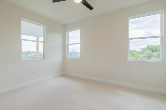 spare room featuring ceiling fan, a healthy amount of sunlight, and carpet floors