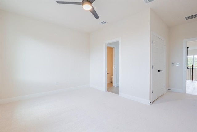 carpeted spare room featuring ceiling fan