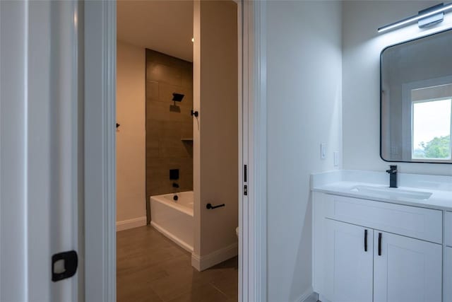 bathroom with vanity and tiled shower / bath combo