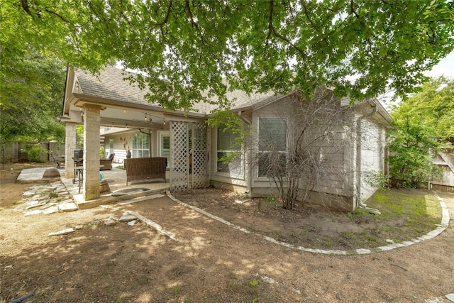 rear view of property featuring a patio and an outdoor living space