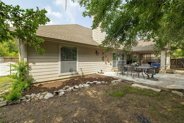 back of property with a patio