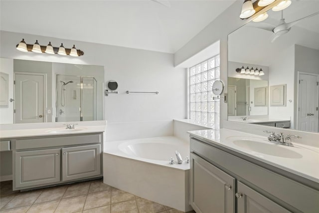 bathroom with tile patterned flooring, vanity, and separate shower and tub