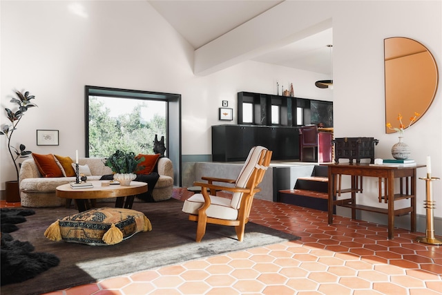 sitting room featuring lofted ceiling and tile patterned floors