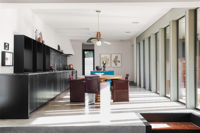 dining area featuring ceiling fan and sink