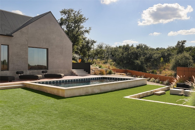 view of swimming pool featuring a lawn