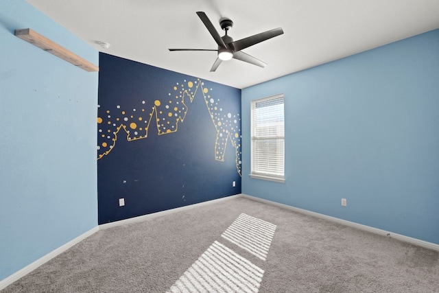 spare room featuring light carpet and ceiling fan