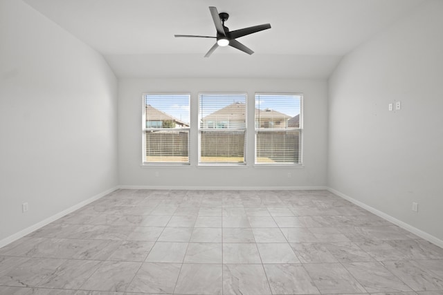 spare room featuring ceiling fan and vaulted ceiling