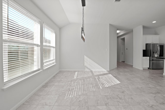 unfurnished living room with a healthy amount of sunlight and lofted ceiling