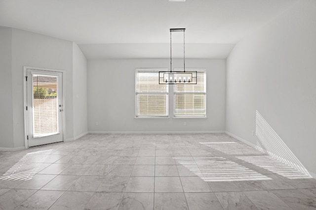 unfurnished dining area featuring an inviting chandelier and vaulted ceiling