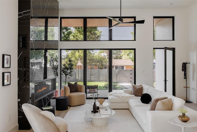 living room featuring a wealth of natural light and a high end fireplace