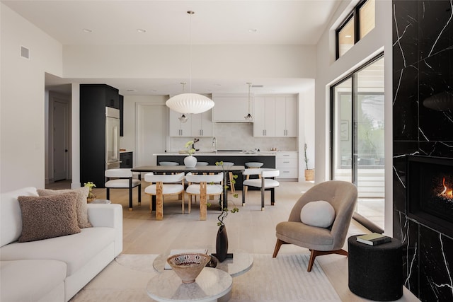 living room featuring light hardwood / wood-style flooring and a fireplace