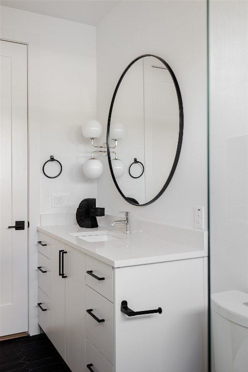 bathroom with toilet and vanity