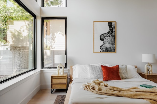 bedroom featuring multiple windows and light wood-type flooring