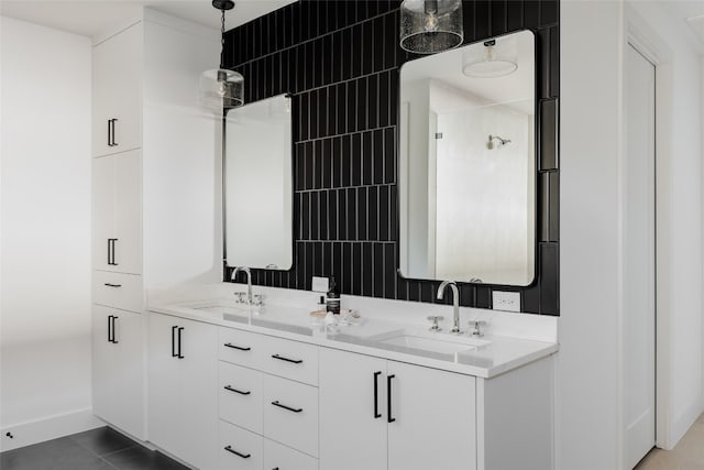 bathroom with a shower, tile patterned floors, and vanity