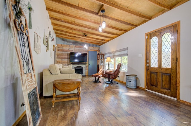 entryway featuring wood ceiling, a stone fireplace, lofted ceiling with beams, and dark hardwood / wood-style floors