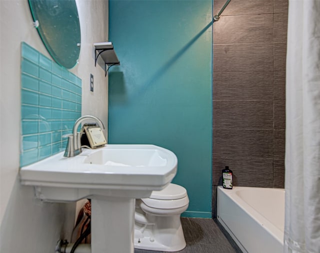 full bathroom featuring sink, shower / bath combination with curtain, and toilet