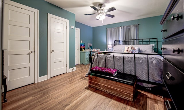 bedroom with ceiling fan and wood-type flooring