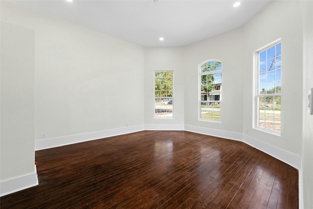 unfurnished room featuring dark wood-type flooring