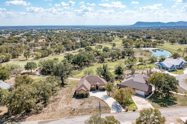 drone / aerial view with a water and mountain view