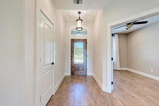 foyer entrance with light hardwood / wood-style flooring and ceiling fan