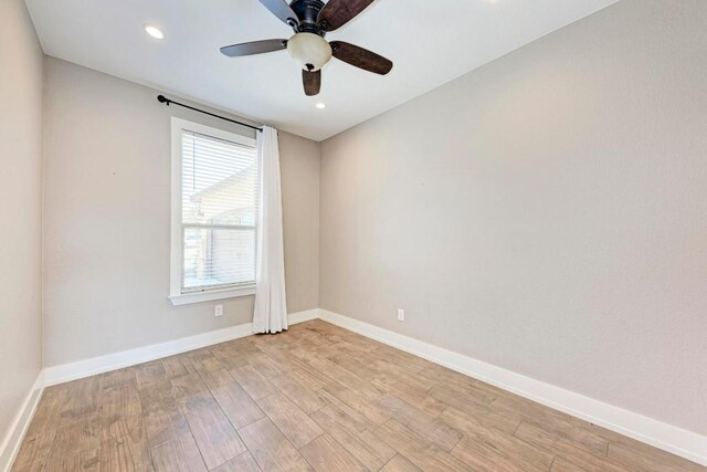 empty room featuring ceiling fan and light hardwood / wood-style floors