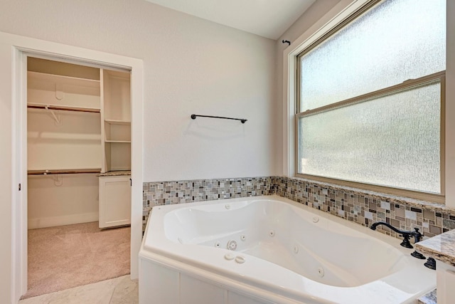 bathroom featuring a bathtub and plenty of natural light