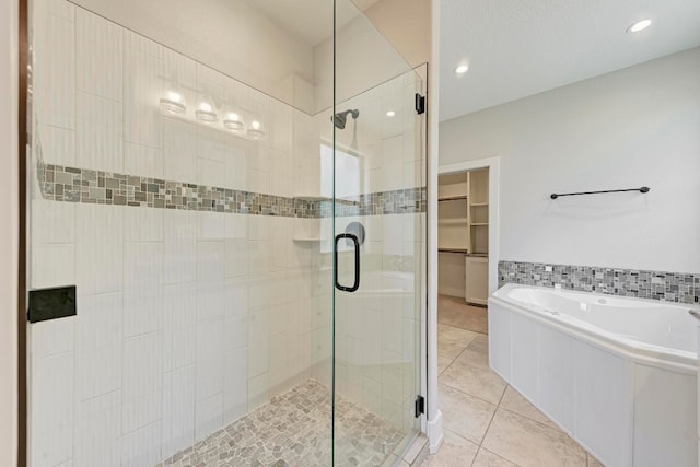 bathroom with separate shower and tub and tile patterned floors