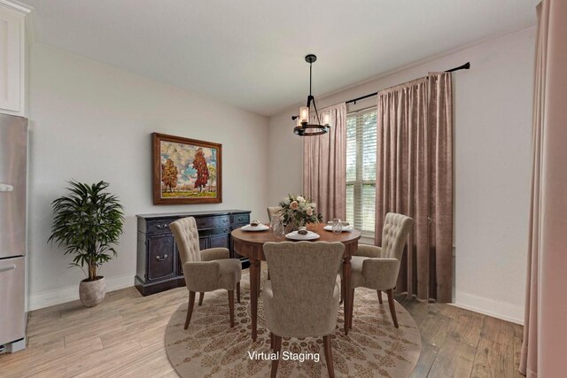 dining space featuring light hardwood / wood-style flooring and a notable chandelier