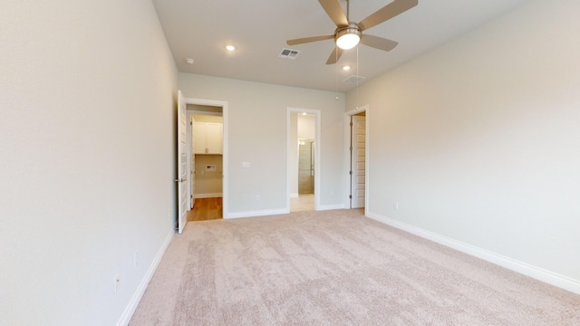 unfurnished bedroom with light carpet, ensuite bath, and ceiling fan