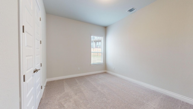 unfurnished room with light colored carpet